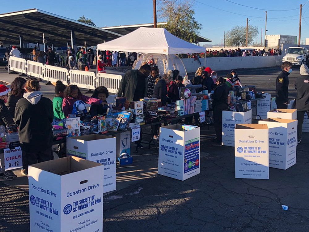 Donation boxes and volunteers at the 2021 toy drive distribution