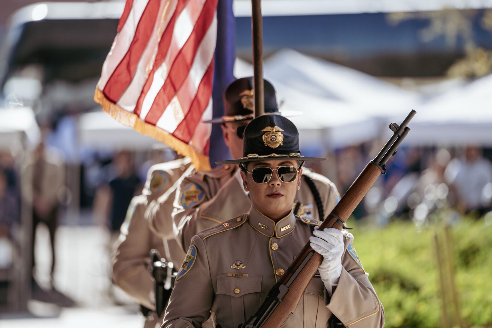 An MCSO honor guard carrying the colors at a memorial ceremony