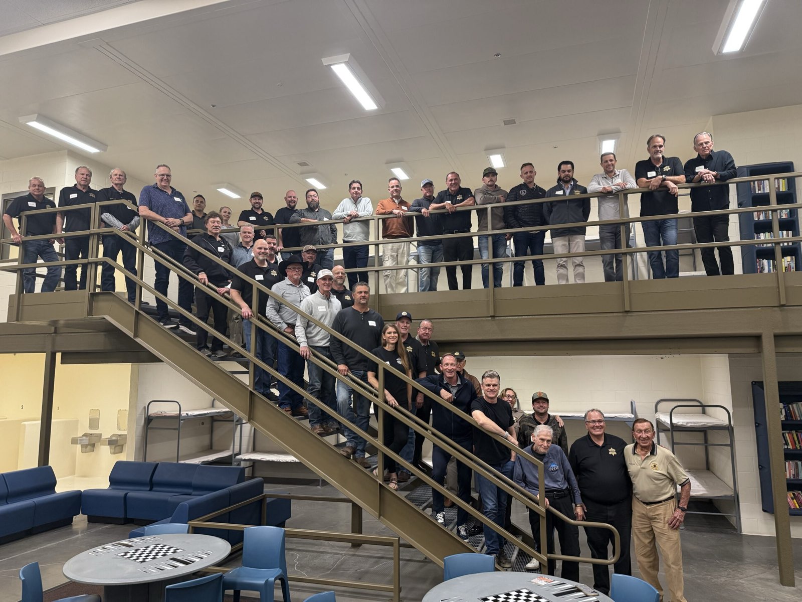Advisory Council members gathered on the stairs and mezzanine during a facility tour